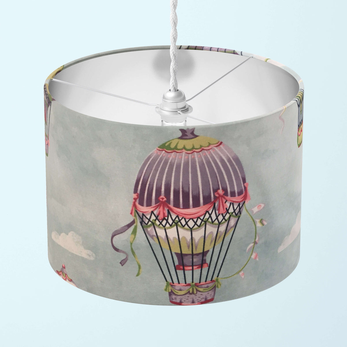 Kids and nursery lampshade with hot air balloon design on a light blue background.