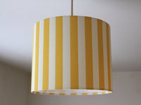 Thin striped ceiling lampshade in yellow and white.