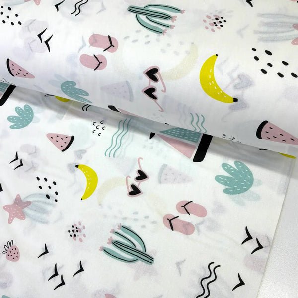 Summer holiday cotton fabric featuring tropical fruit, cacti, flip flops, sunglasses and watermelon on a white background.
