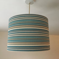 A teal blue and brown striped ceiling pendant lampshade.