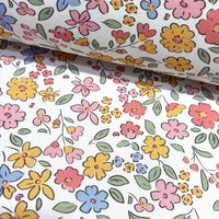 Tiny floral fabric patterned with colorful flowers on a white background.