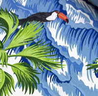Toucan bird and palm leaves with blue wave patterned fabric.