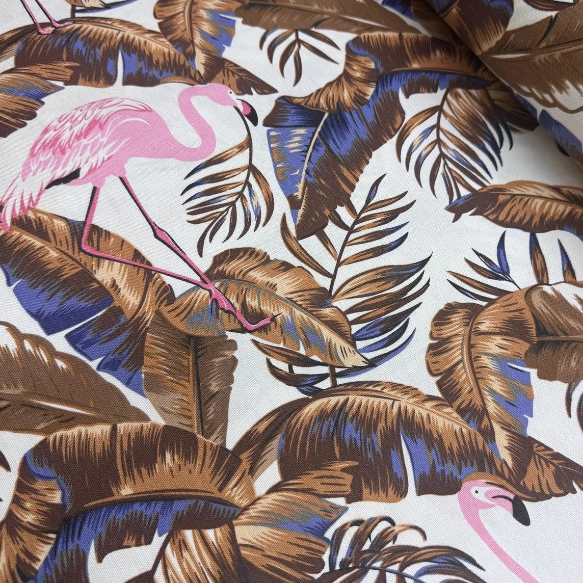 Tropical jungle fabric with pink flamingo and brown leaves on a white background.