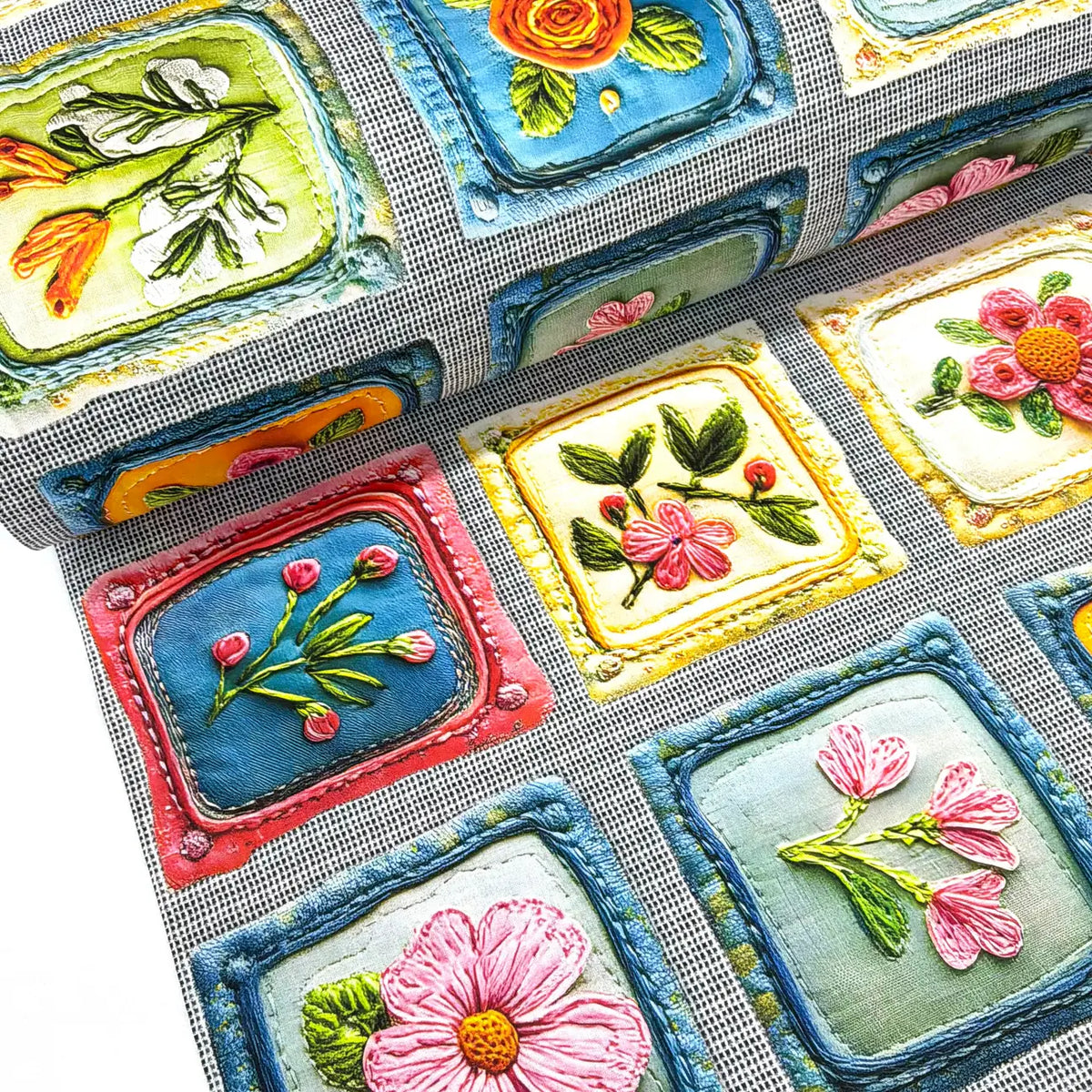 Vintage floral patchwork 100% cotton fabric featuring colourful embroidered-style flower motifs in decorative framed squares on a grey linen-effect background.