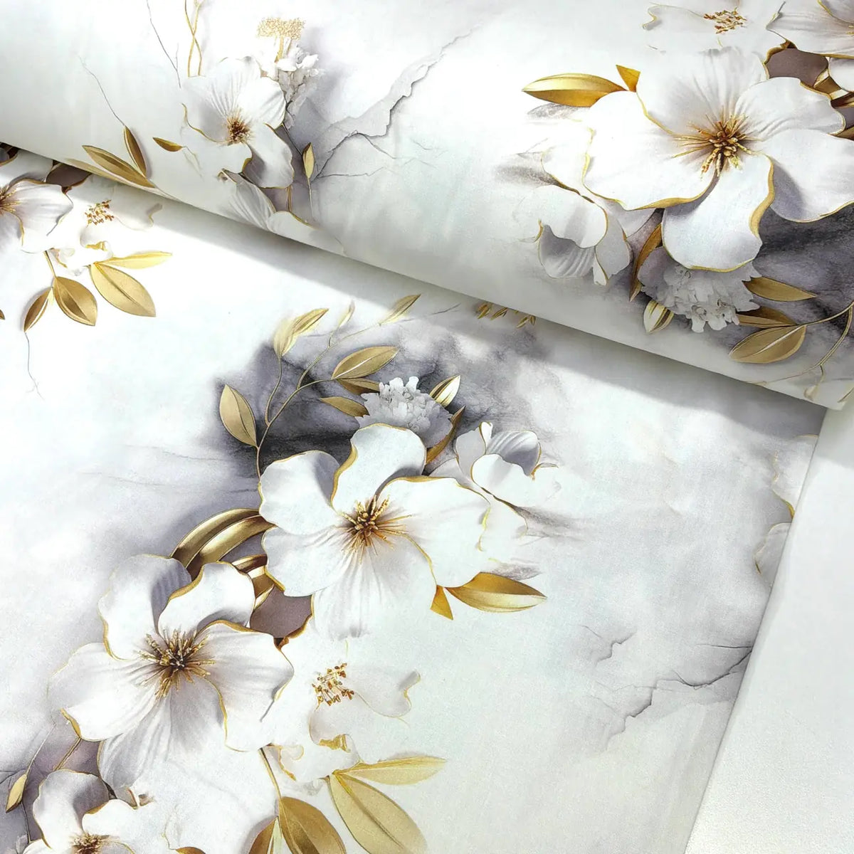 White and gold floral cotton poplin fabric featuring magnolia flowers, gold-effect botanical leaves and soft marble detailing on a white background.