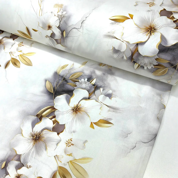 White and gold floral cotton poplin fabric featuring magnolia flowers, gold-effect botanical leaves and soft marble detailing on a white background.