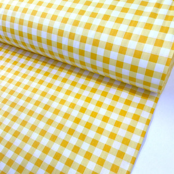 Yellow and white gingham cotton fabric with a classic check pattern, ideal for quilting, sewing, dressmaking, patchwork, crafts, and home décor.