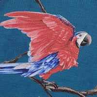 Upholstery curtain fabric orinted in red blue exotic parrot on a blue background.