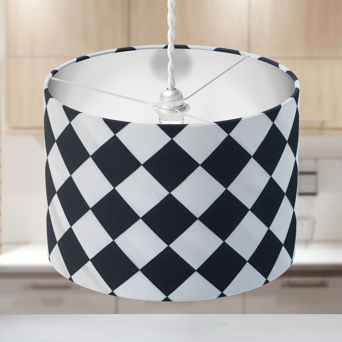 Black and white check ceiling lampshade on a neutral background in a kitchen.