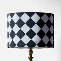 Table and floor lampshade with black and white diamond pattern on a white background.