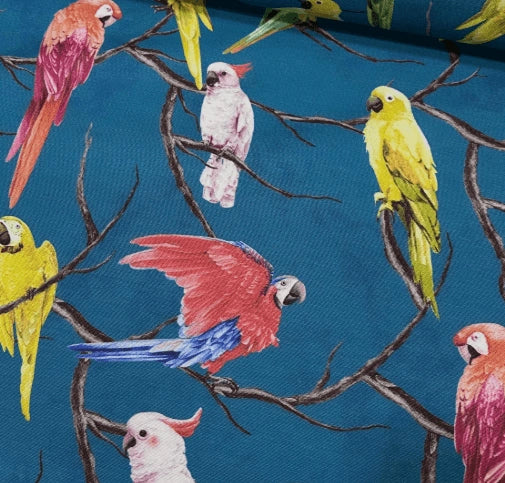 Exotic upholstery fabric with colourful parrot pattern on a blue background.