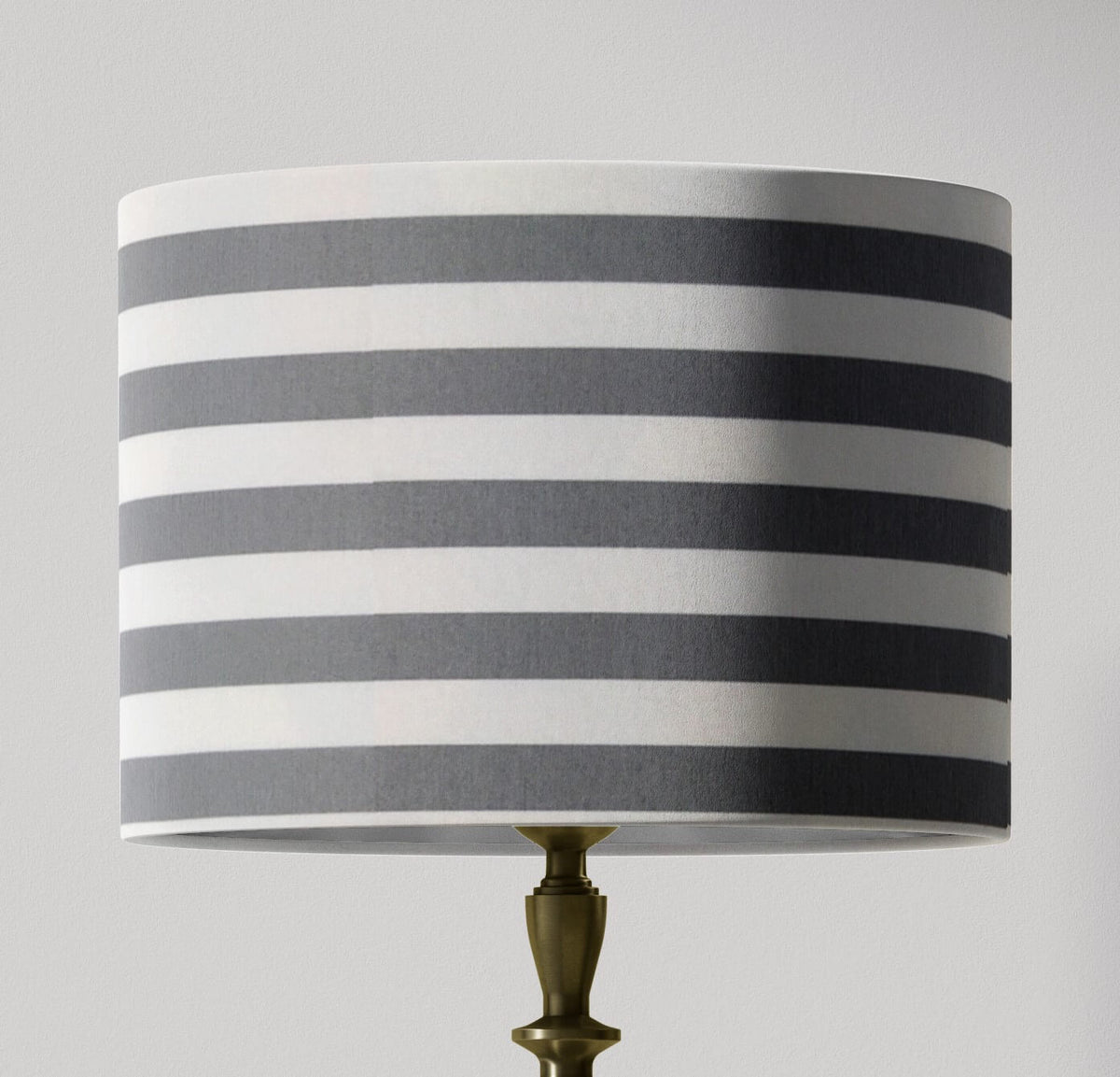 Boho contemporary grey striped lampshade with grey and white stripes on a gray background.