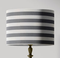 Boho contemporary grey striped lampshade with grey and white stripes on a gray background.