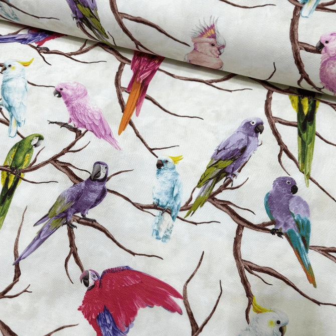 Tropical bird upholstery curtain fabric printed in red, lilac, pink, green, light blue parrots on a white background.  