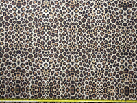 Brown leopard print upholstery fabric with a measuring tape at the bottom.