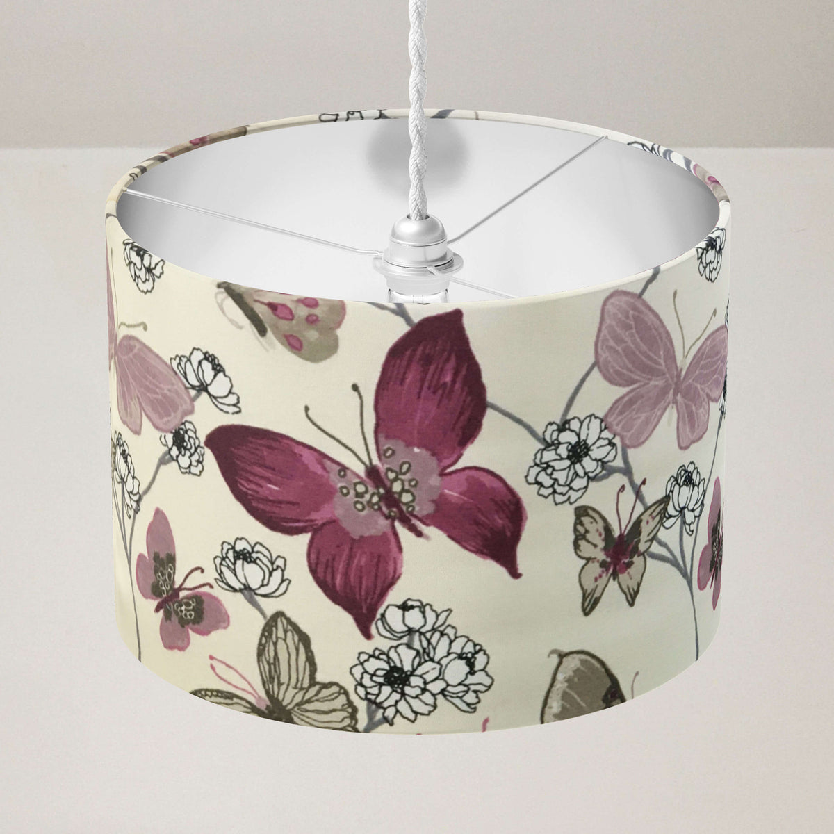 Ceiling lampshade with exotic butterfly and flowers print on a plain background.