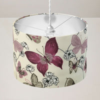 Ceiling lampshade with exotic butterfly and flowers print on a plain background.
