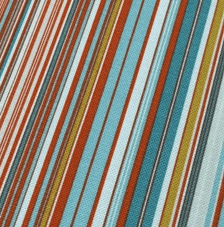 Close-up of fabric with multicolored striped pattern in orange, red, mustard and teal blue.