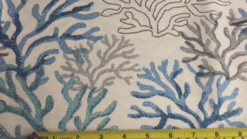 Blue ocean fabric with grey, blue and green coral reefs on an ivory background.