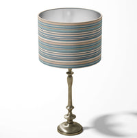 Horizontal thin stripe table and floor lampshade in turquoise and beige colours.