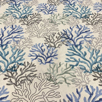 Blue ocean fabric with a coral reef pattern, suitable for upholstery and home decor projects.
