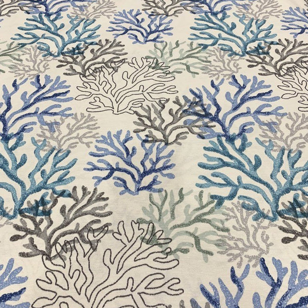 Blue ocean fabric with a coral reef pattern, suitable for upholstery and home decor projects.