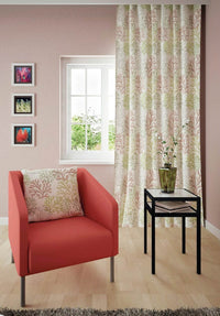 Living room decorated with a red sofa, cushion patterned with coral reefs and a curtain patterned with coral reefs.