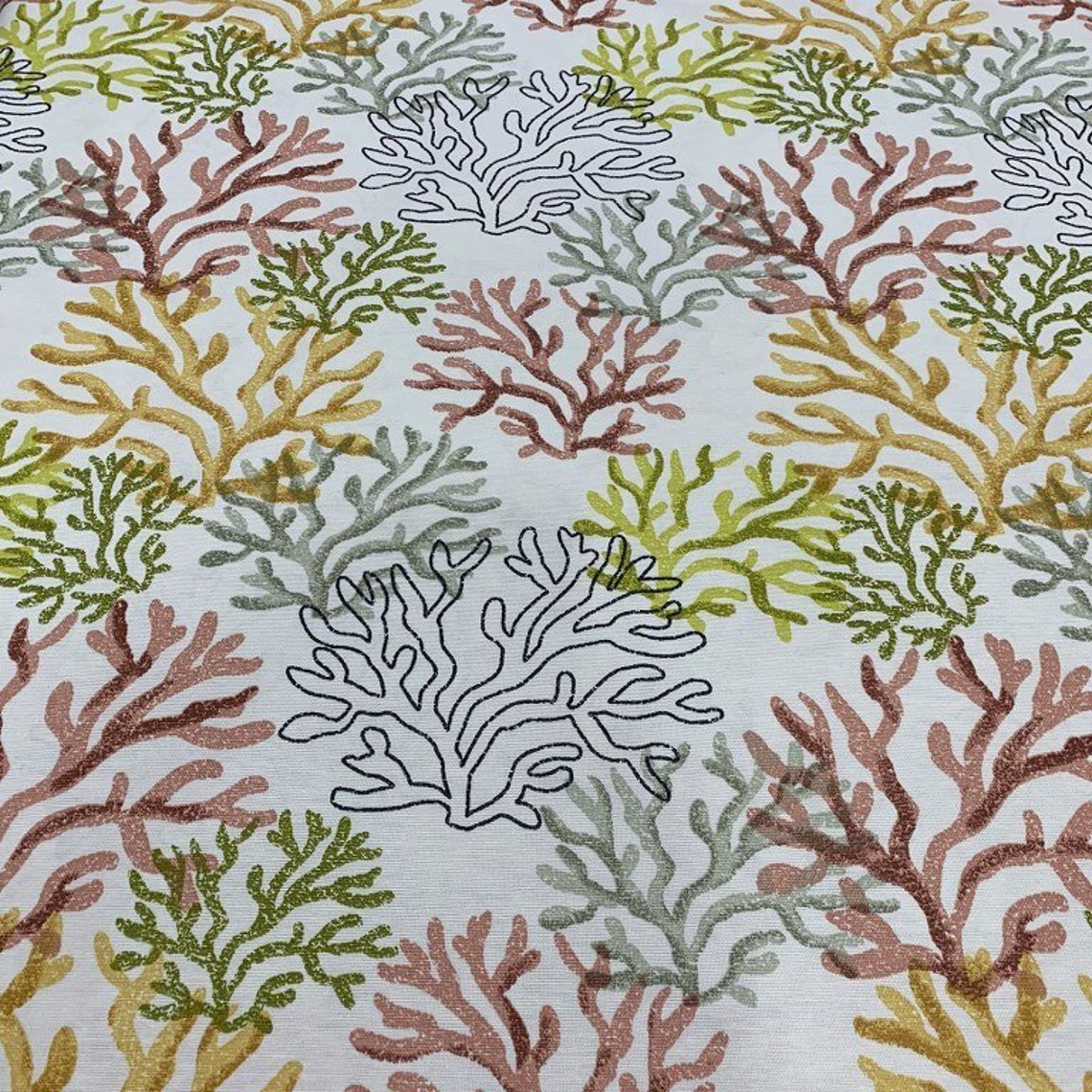 Yellow ocean fabric with green and mustard coral reef pattern on a white background, suitable for upholstery and curtain projects.