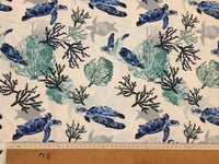 Sea turtles and seaweeds patterned ocean upholstery fabric in blue and white with a ruler showing pattern repeat.